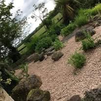 Landscaped rock garden with gravel path and ornamental plants — Midwest Garden Maintenance